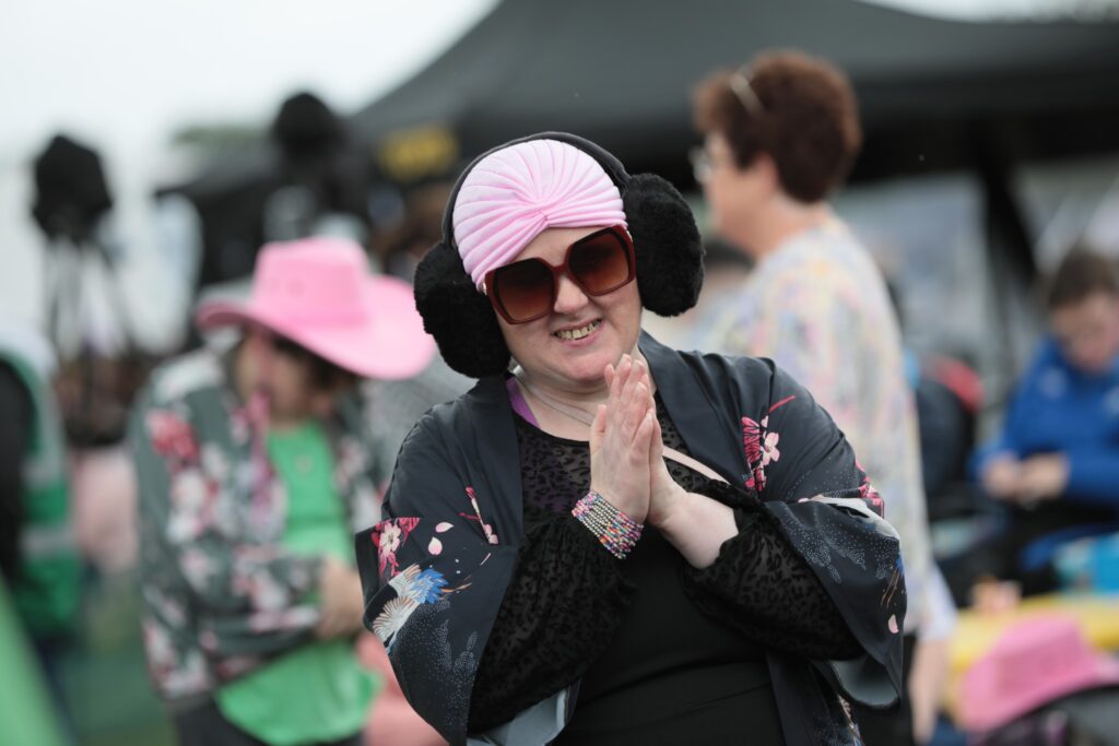 A an attendee at Ablefest smiling in the crowd