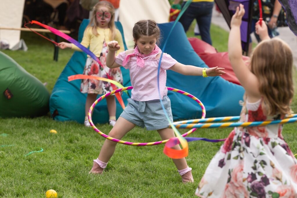 A girl playing happily with a hula hoop, outdoors at Ireland's Ablefest