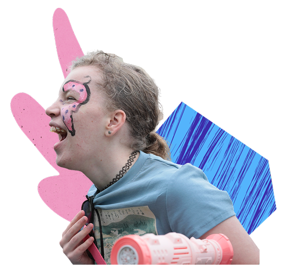 Photo of a young girl laughing, wearing a fun face painting on her face, enjoying one of the Able Events festivals.