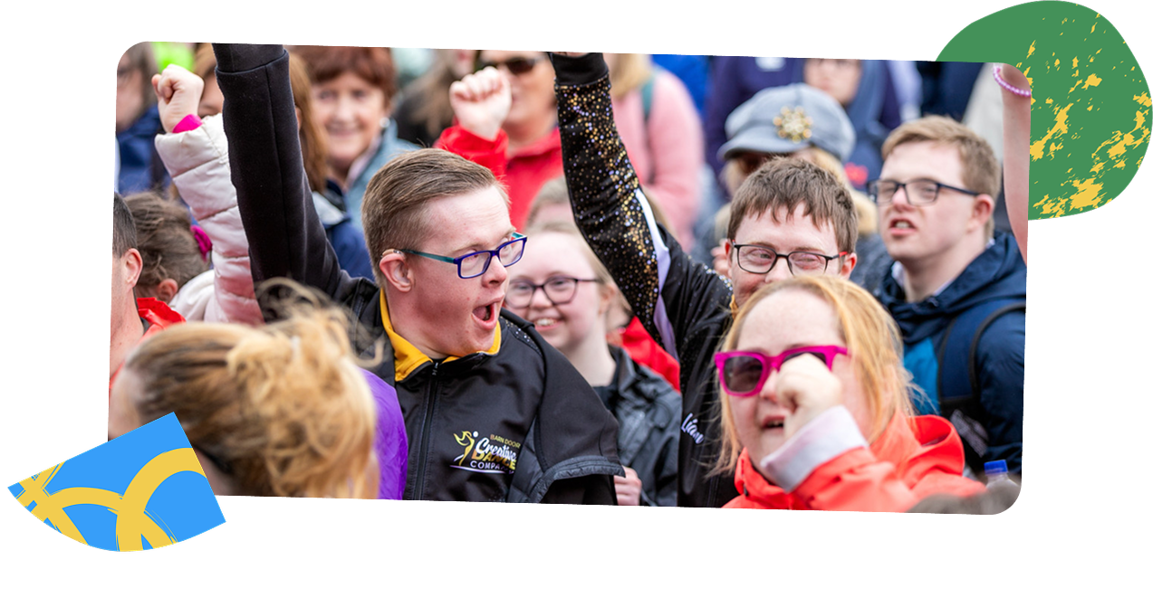 Group of young people talking animatedly and smiling in the crowd attending Ablefest
