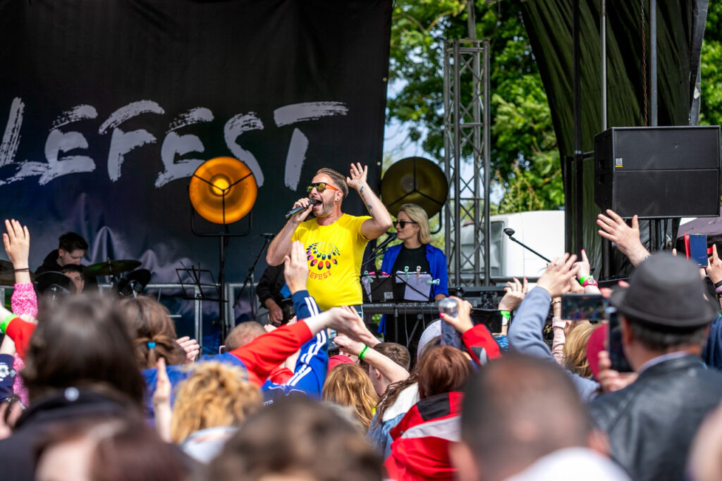 Artist on main stage at Ablefest, in front of a large crowd