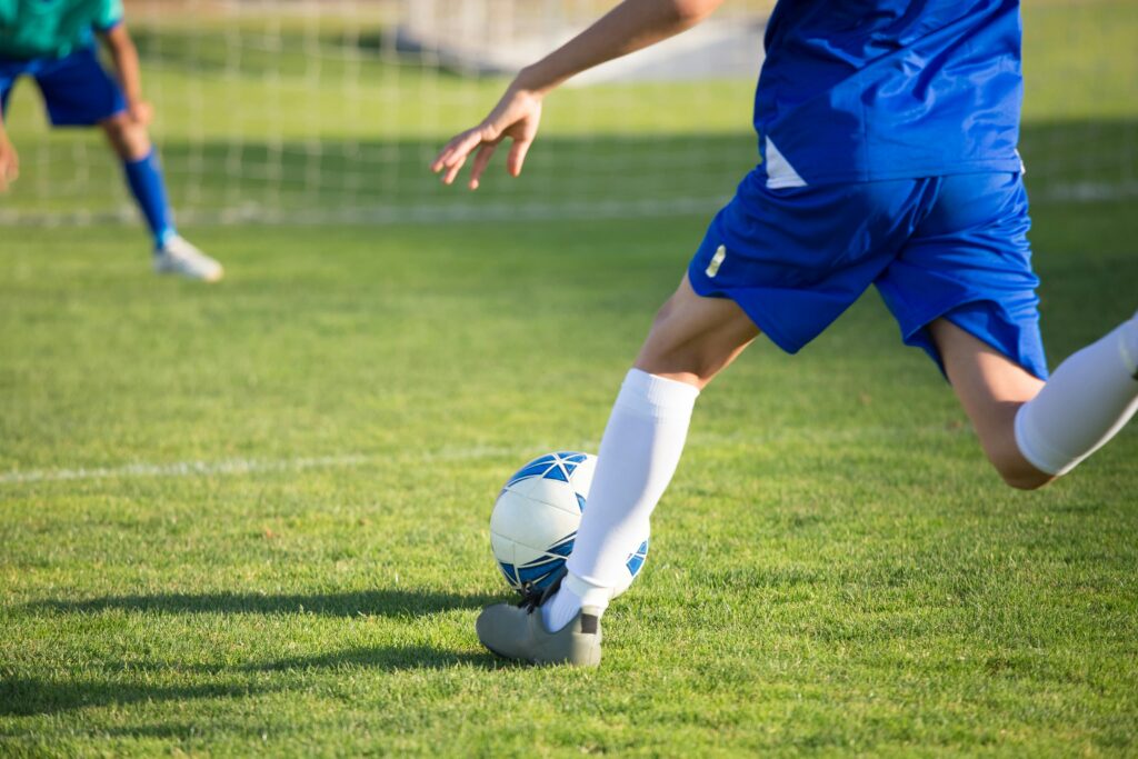 Young people playing soccer outdoors at SoccerFest